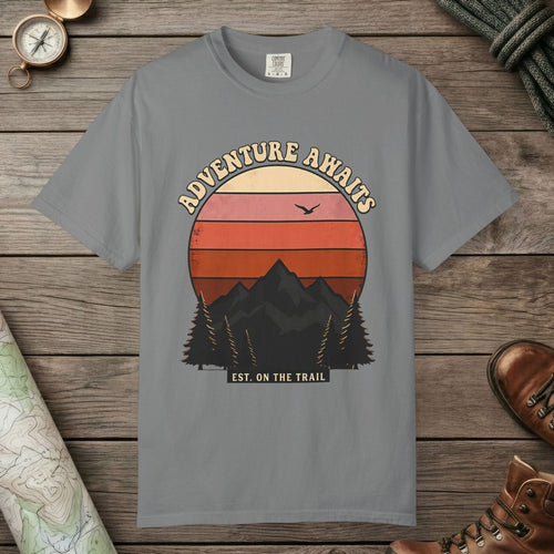 Grey color unisex graphic t-shirt with "Adventure Awaits Retro Sunset" design