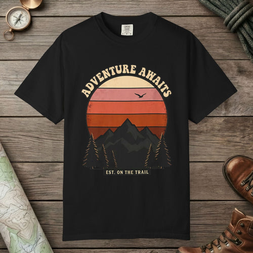 Black color unisex graphic t-shirt with "Adventure Awaits Retro Sunset" design