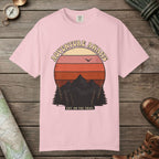 Blossom color unisex graphic t-shirt with "Adventure Awaits Retro Sunset" design