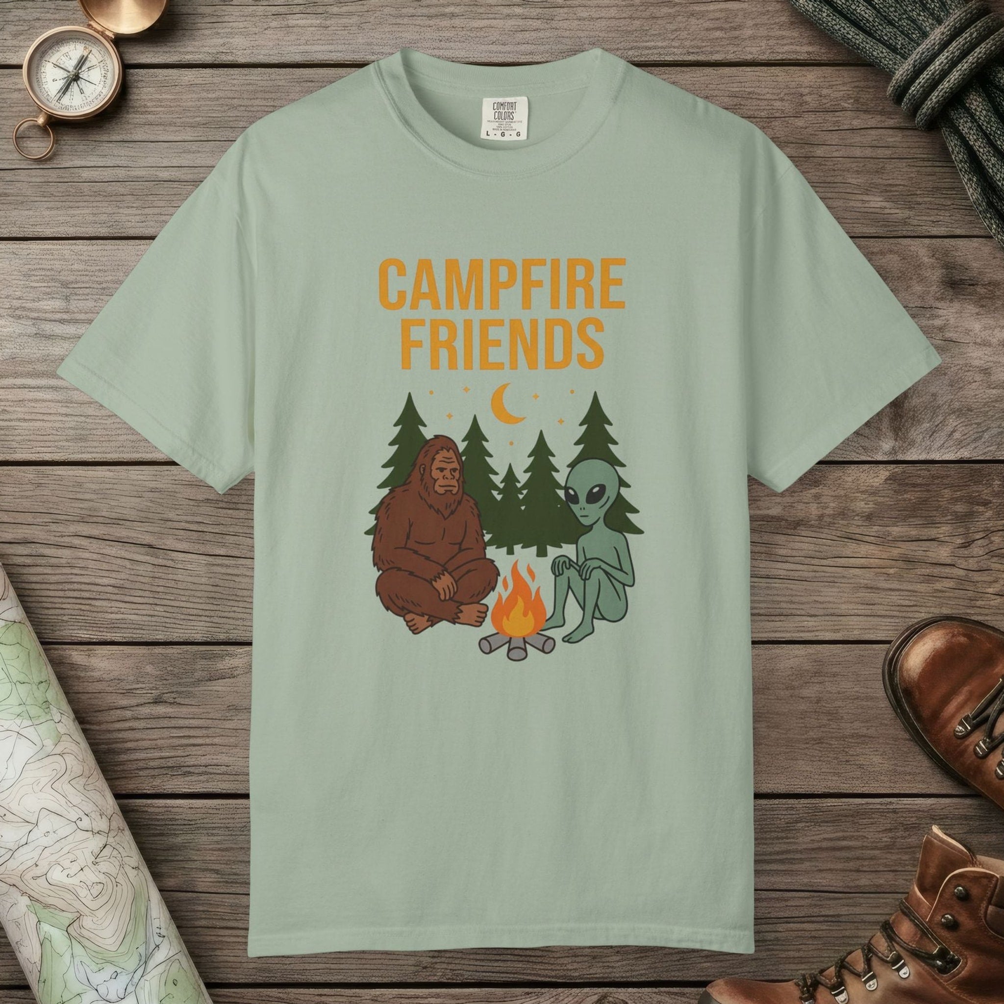 Bay color unisex graphic t-shirt with "Bigfoot And Alien Campfire" design