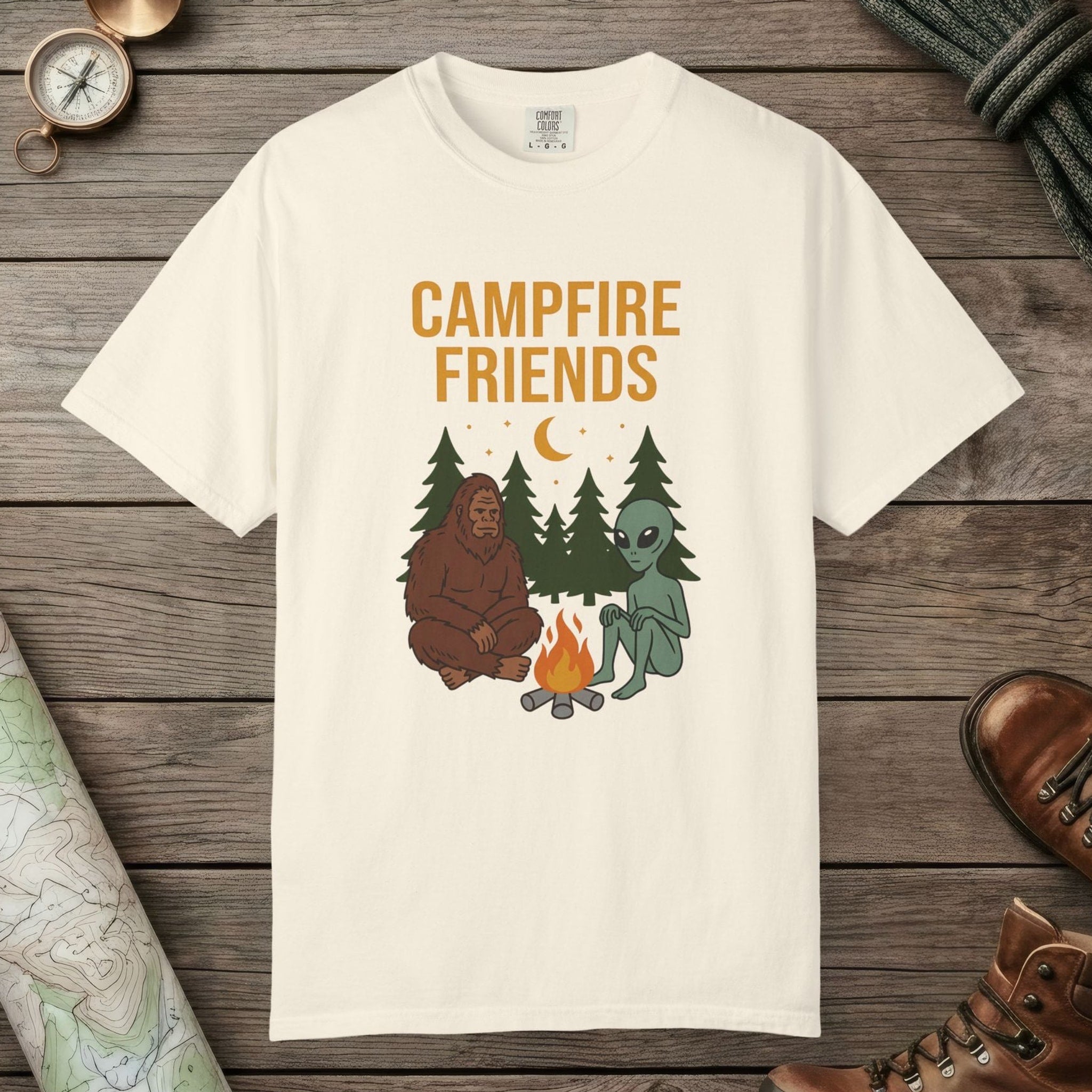 Ivory color unisex graphic t-shirt with "Bigfoot And Alien Campfire" design