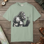 Bay color unisex graphic t-shirt with "Bigfoot Blowing Wishes" design