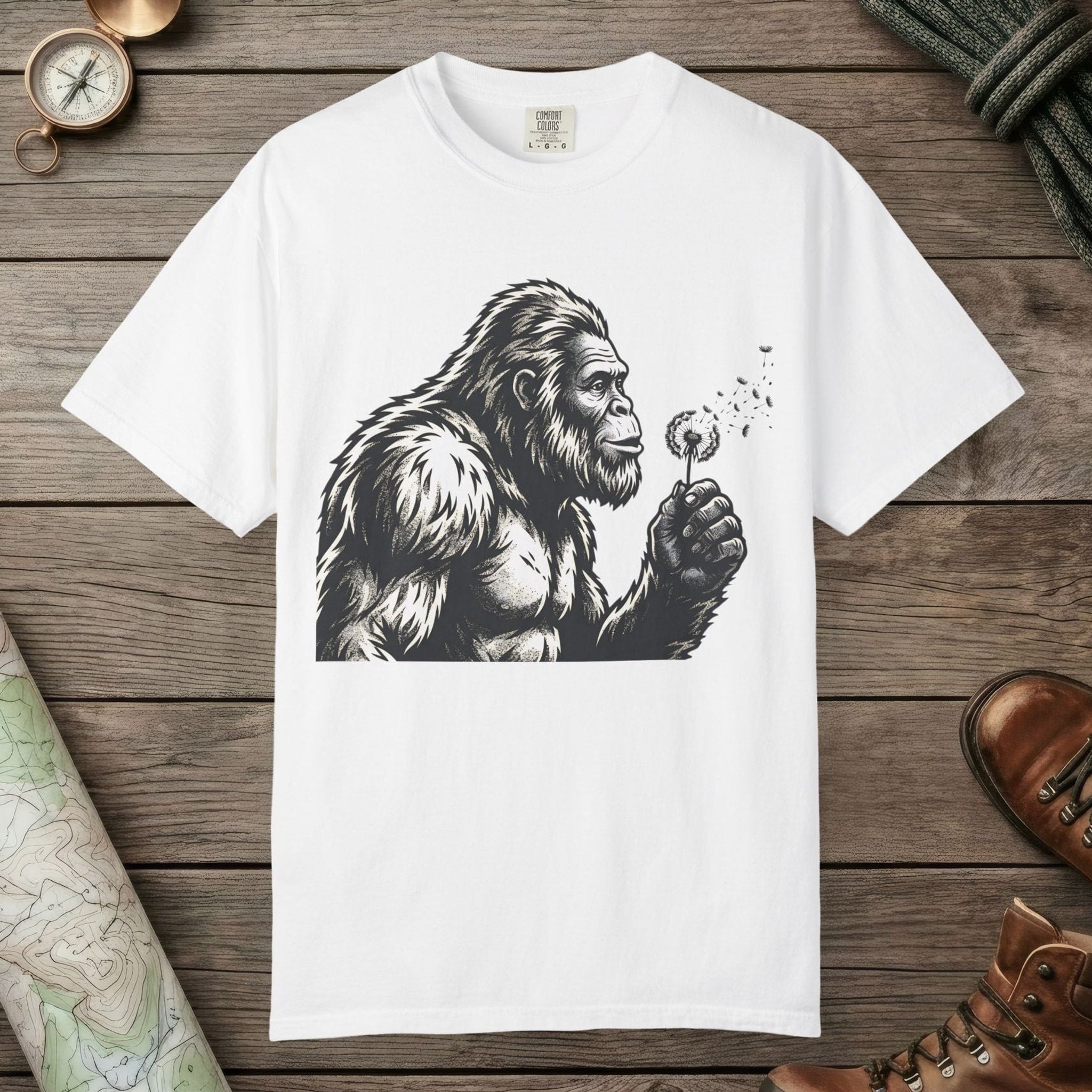 White color unisex graphic t-shirt with "Bigfoot Blowing Wishes" design