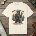 Ivory color unisex graphic t-shirt with "Born To Roam Bear" design