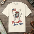 Ivory color unisex graphic t-shirt with "Born Wild Raccoon" design