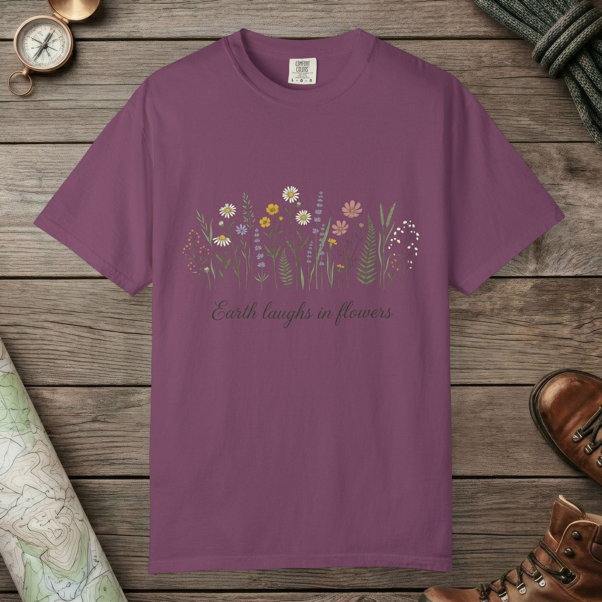 Berry color unisex graphic t-shirt with "Earth Laughs In Flowers" design