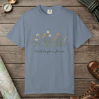 Blue Jean color unisex graphic t-shirt with "Earth Laughs In Flowers" design