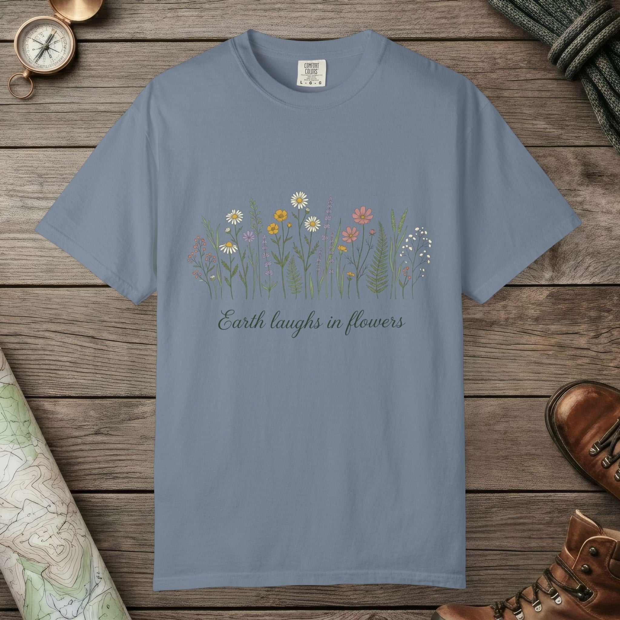 Blue Jean color unisex graphic t-shirt with "Earth Laughs In Flowers" design