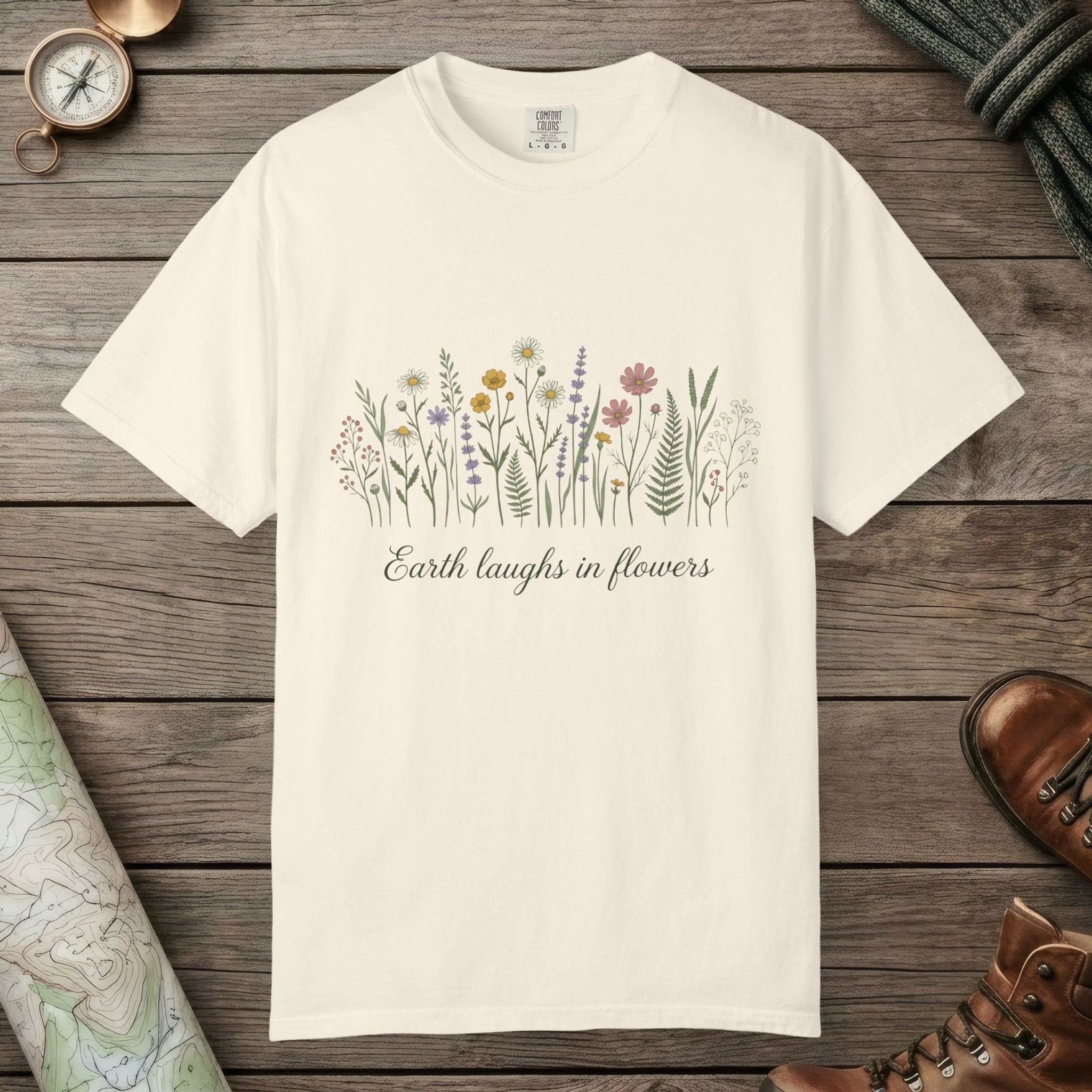 Ivory color unisex graphic t-shirt with "Earth Laughs In Flowers" design