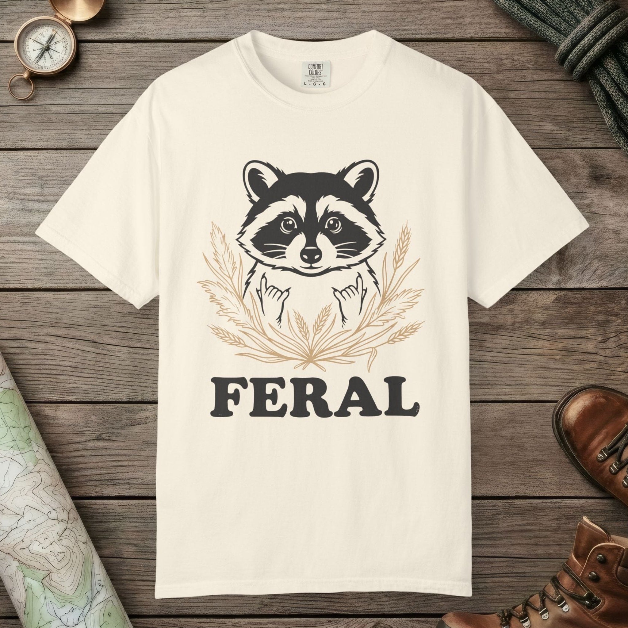 Ivory color unisex graphic t-shirt with "Feral Raccoon" design