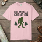 Blossom color unisex graphic t-shirt with "Hide And Seek Champion" design