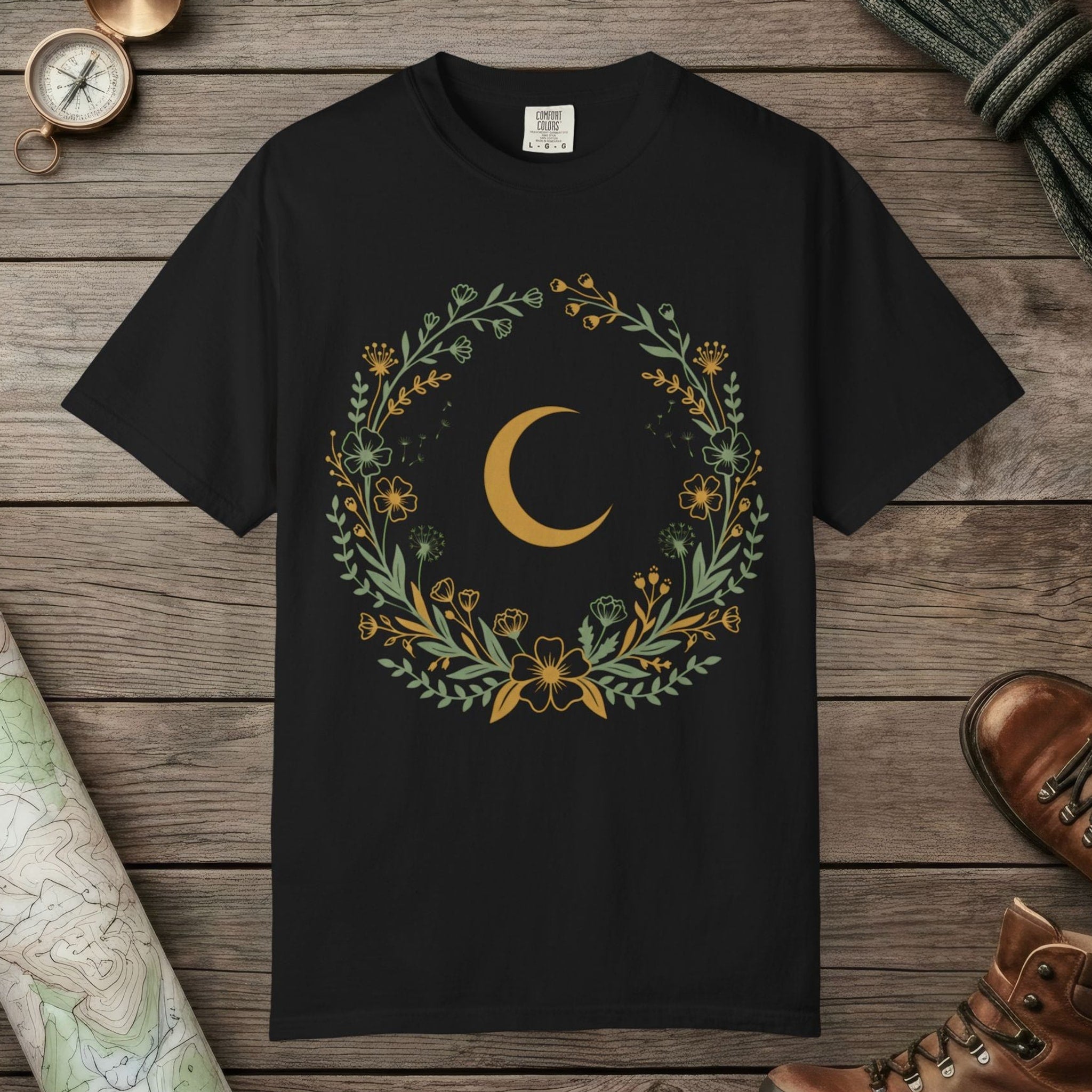Black color unisex graphic t-shirt with "Moon & Wildflower Wreath" design