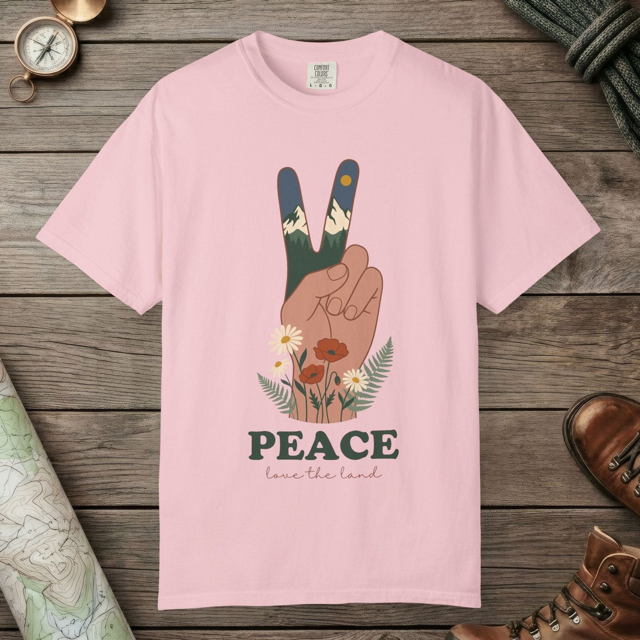 Blossom color unisex graphic t-shirt with "Peace Love The Land" design