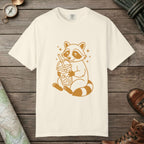 Ivory color unisex graphic t-shirt with "Raccoon with Iced Drink" design