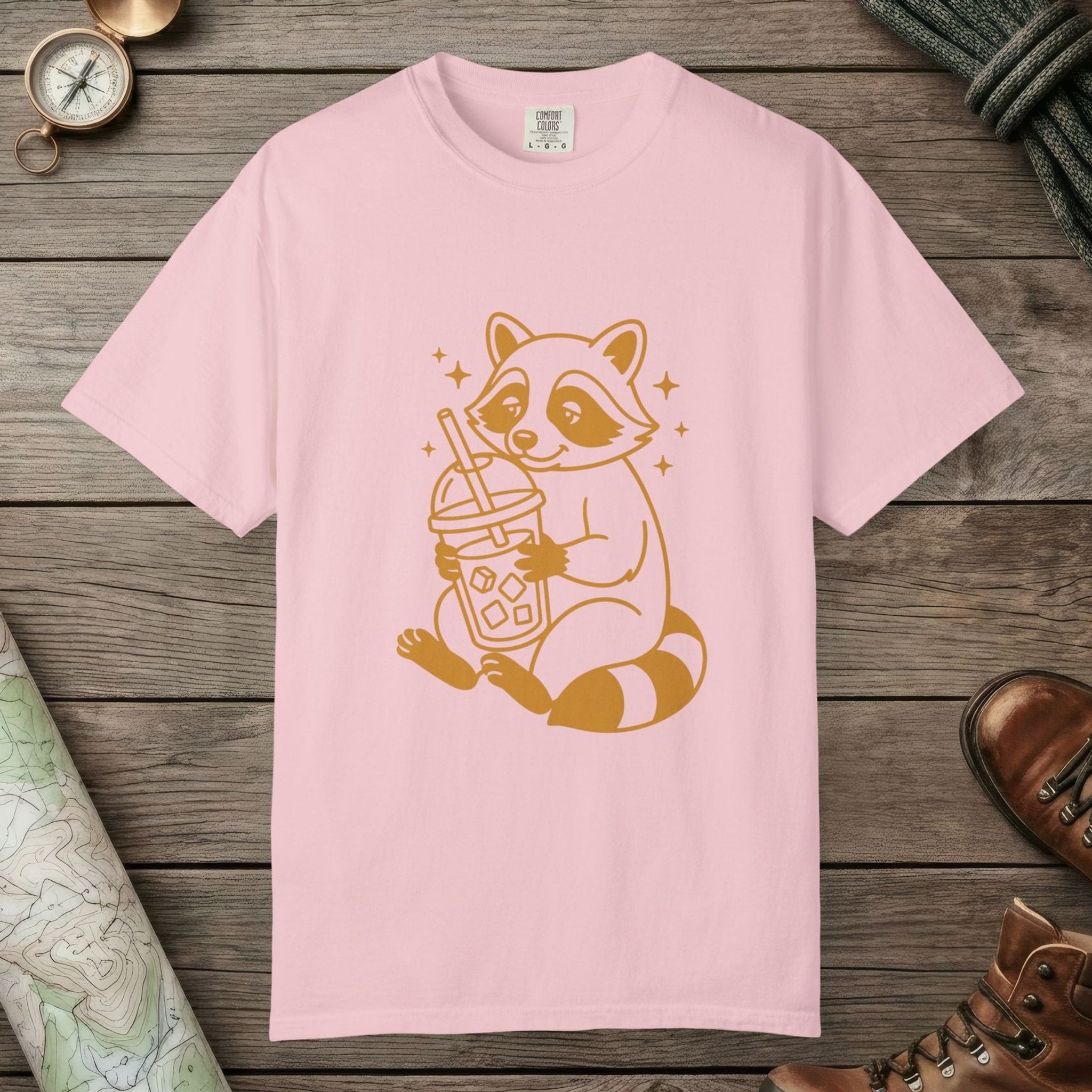 Blossom color unisex graphic t-shirt with "Raccoon with Iced Drink" design