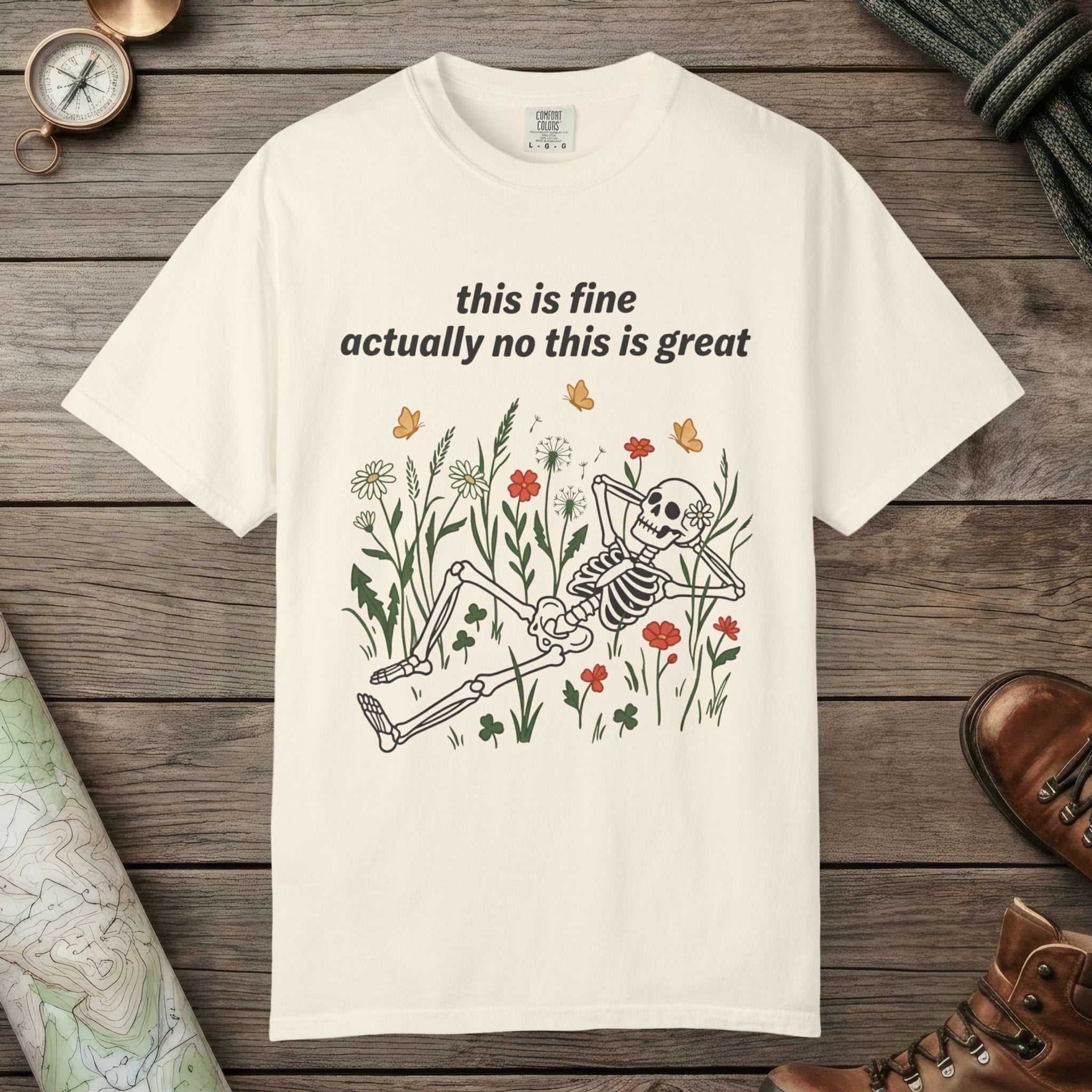 Ivory color unisex graphic t-shirt with "Skeleton in Wildflower Field" design