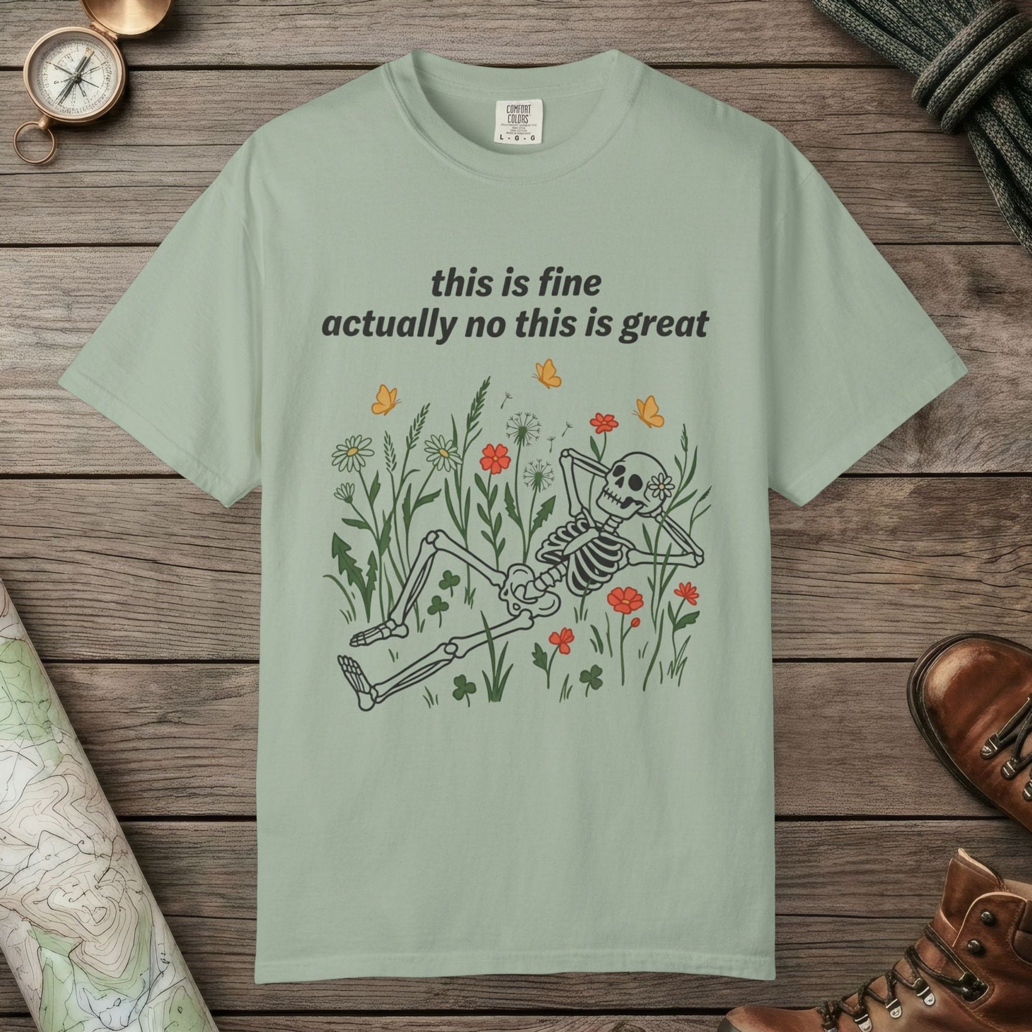 Bay color unisex graphic t-shirt with "Skeleton in Wildflower Field" design