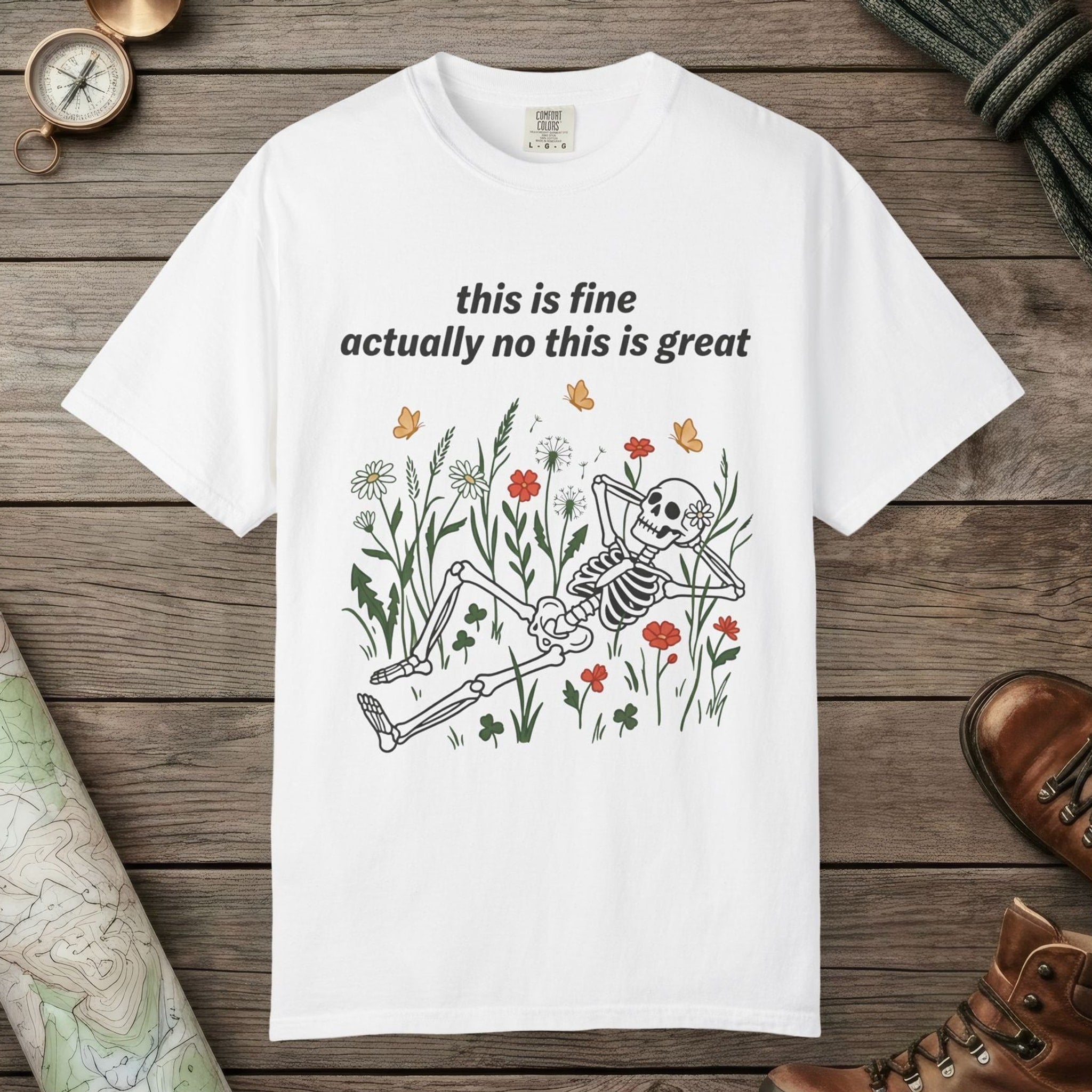White color unisex graphic t-shirt with "Skeleton in Wildflower Field" design