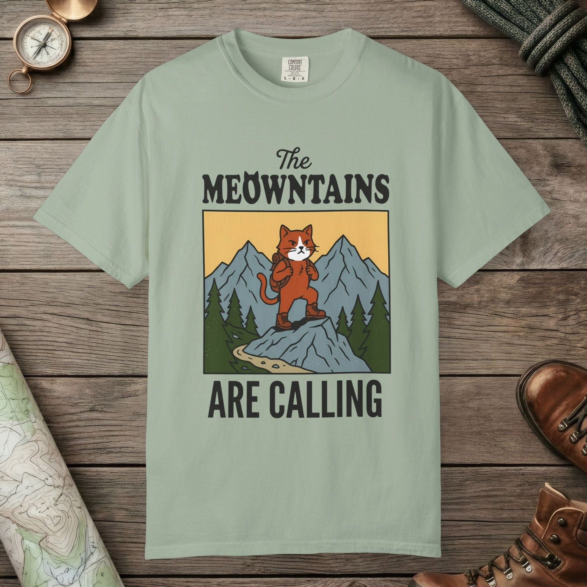 Bay color unisex graphic t-shirt with "The Meowntains Are Calling" design