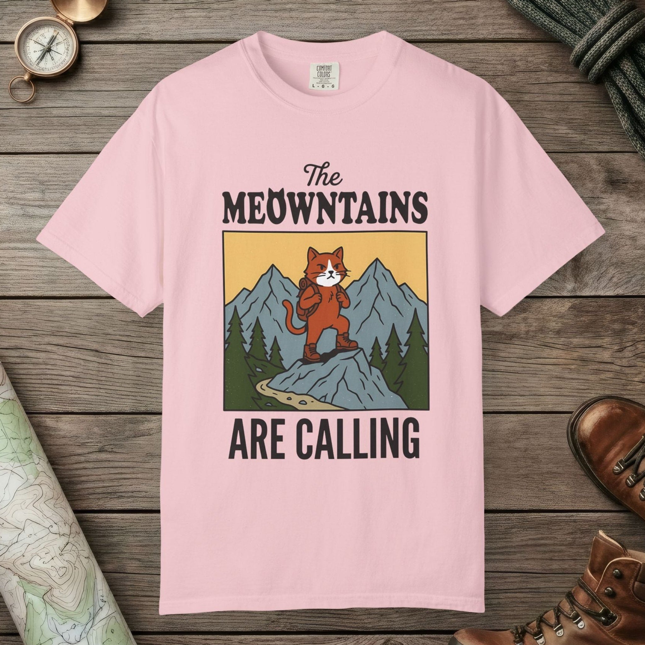 Blossom color unisex graphic t-shirt with "The Meowntains Are Calling" design