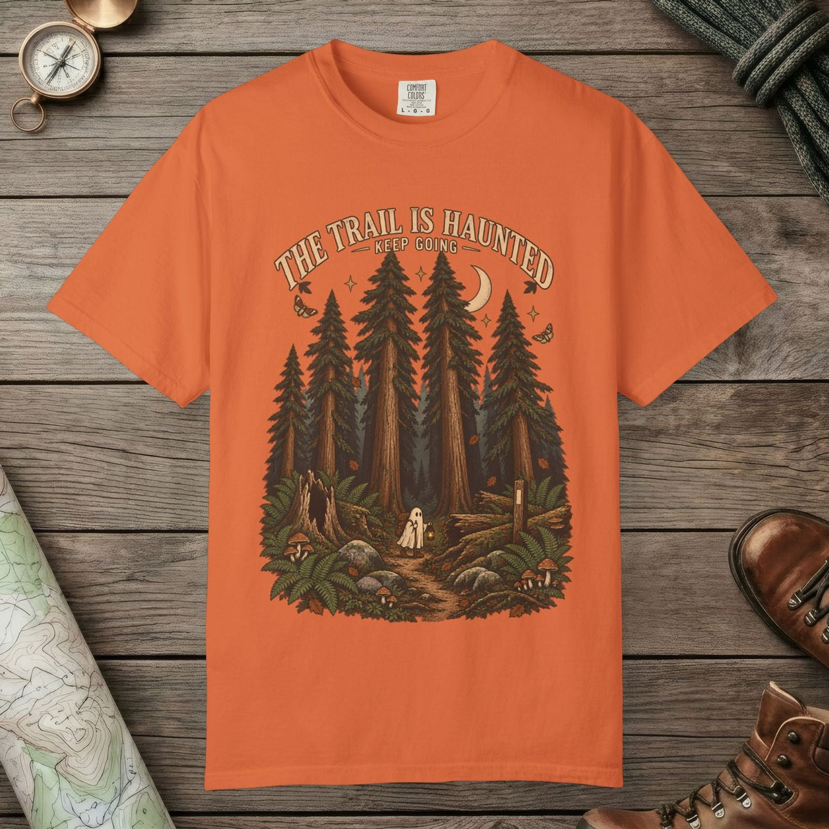 Burnt Orange color unisex graphic t-shirt with "Trail Is Haunted" design