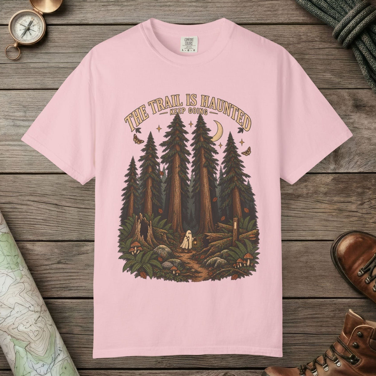 Blossom color unisex graphic t-shirt with "Trail Is Haunted" design