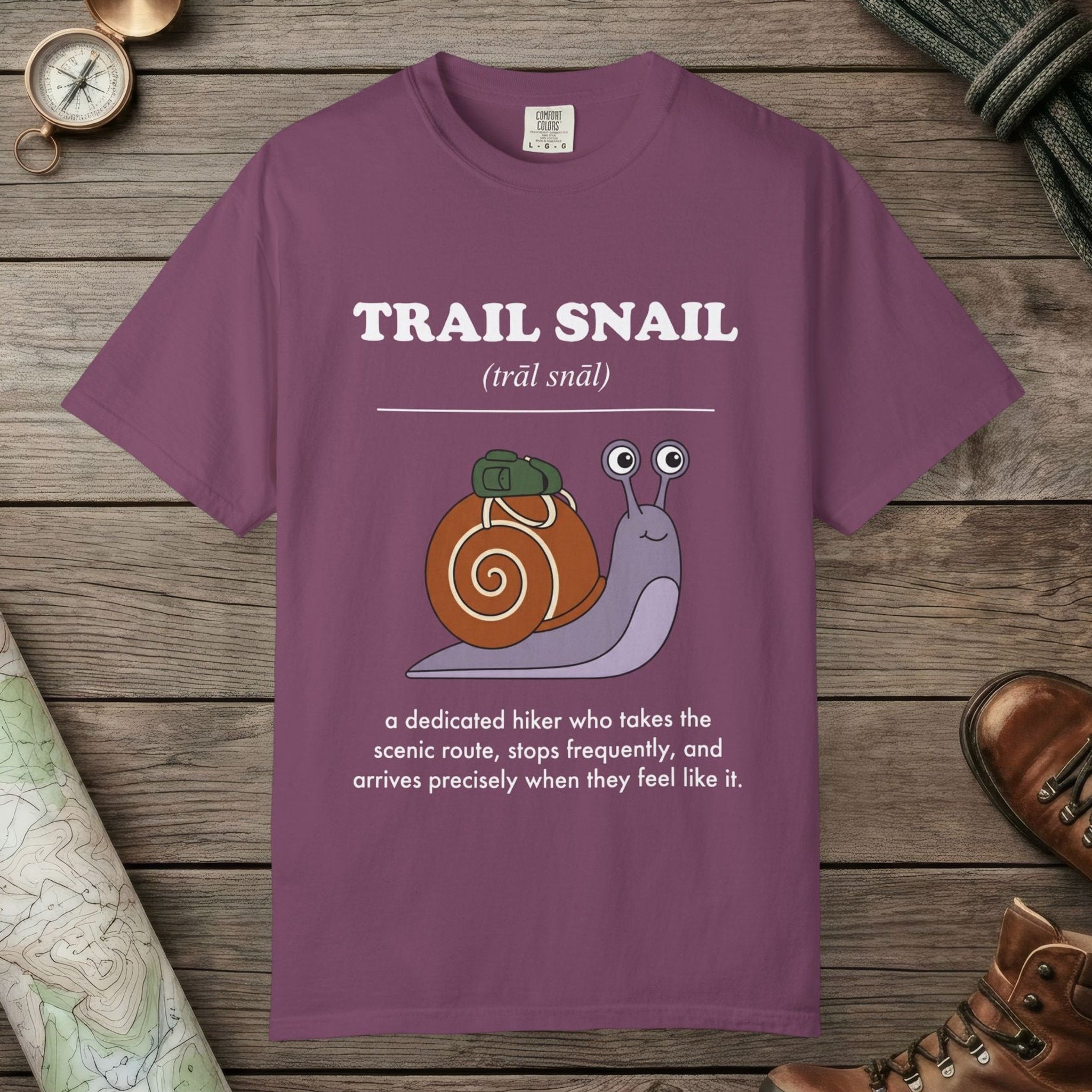 Berry color unisex graphic t-shirt with "Trail Snail Definition" design