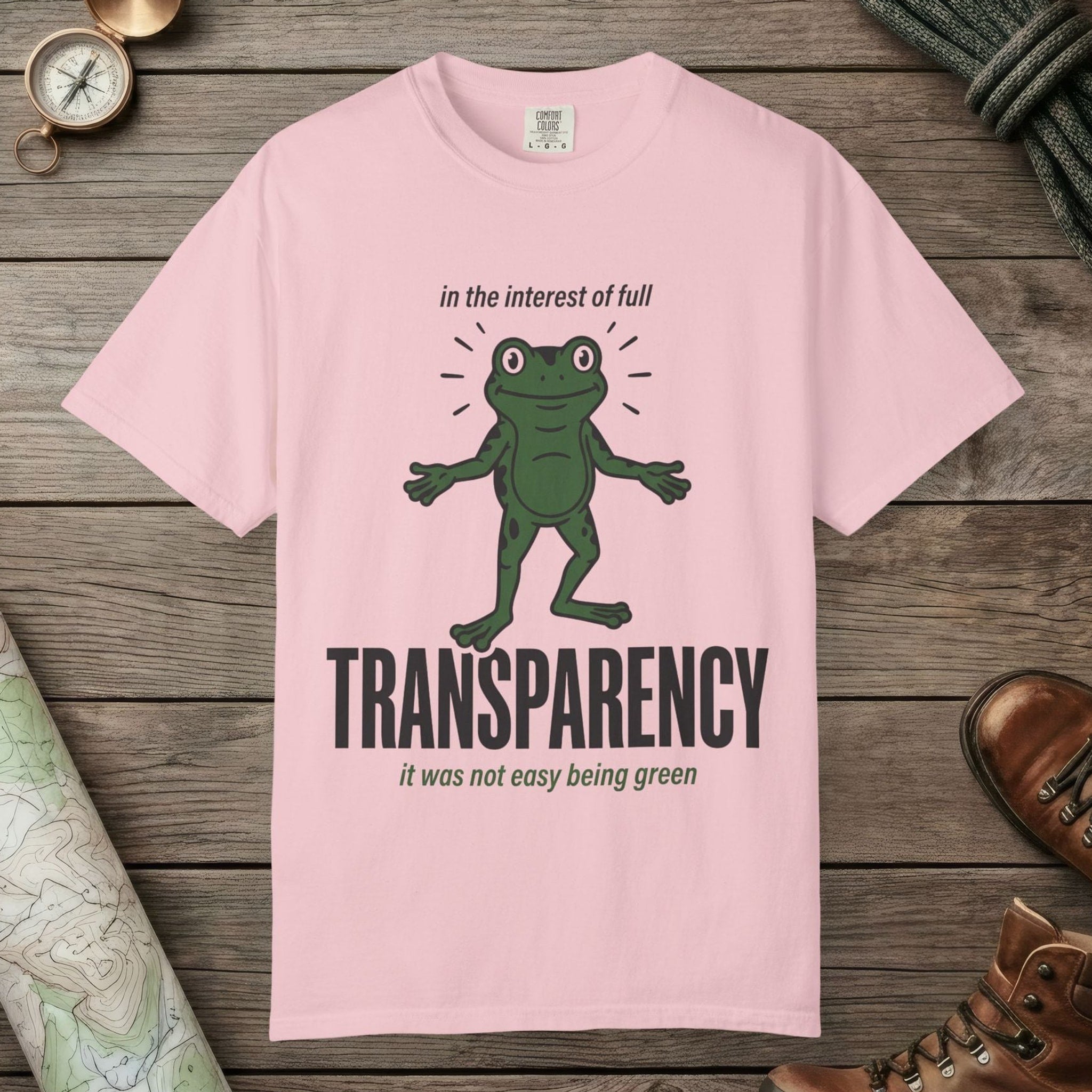 Blossom color unisex graphic t-shirt with "Transparent About It Frog" design