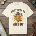 Ivory color unisex graphic t-shirt with "Vibes Off Raccoon" design