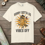 Ivory color unisex graphic t-shirt with "Vibes Off Raccoon" design