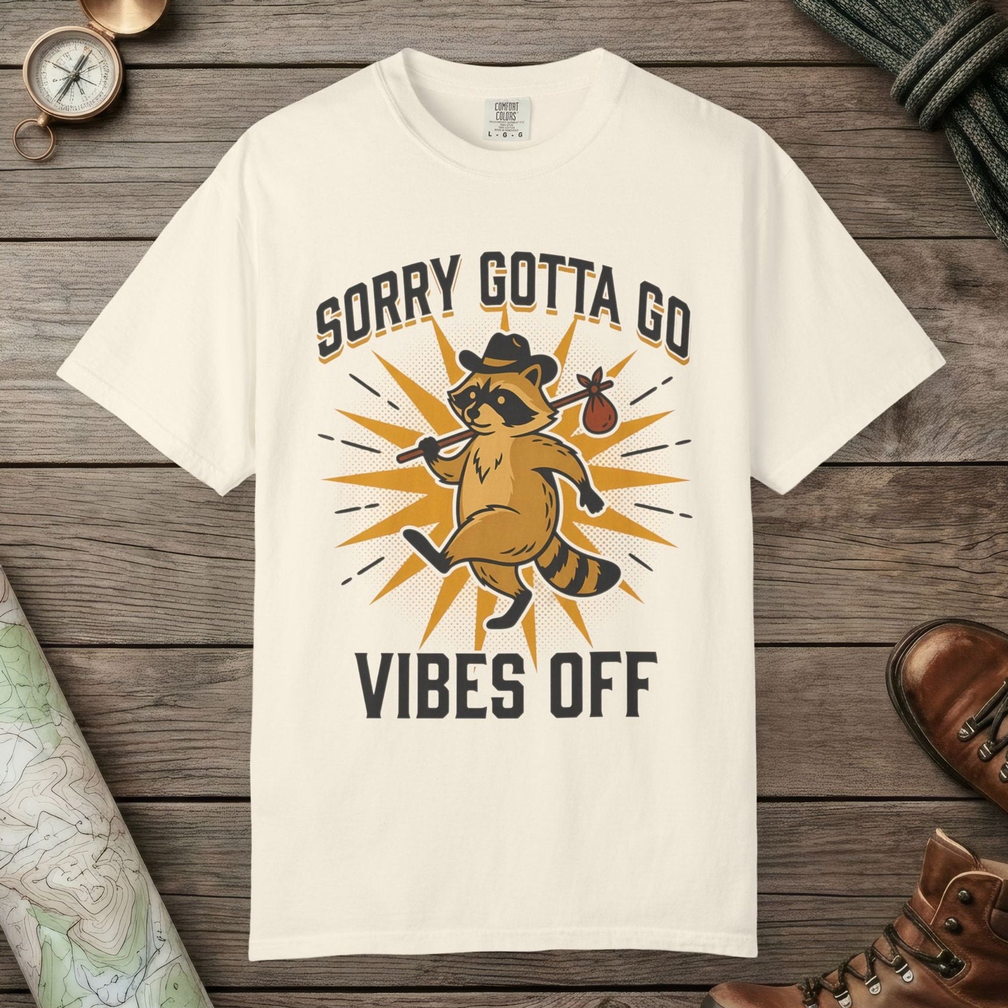 Ivory color unisex graphic t-shirt with "Vibes Off Raccoon" design