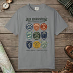 Grey color unisex graphic t-shirt with "Vintage Trail Patches" design