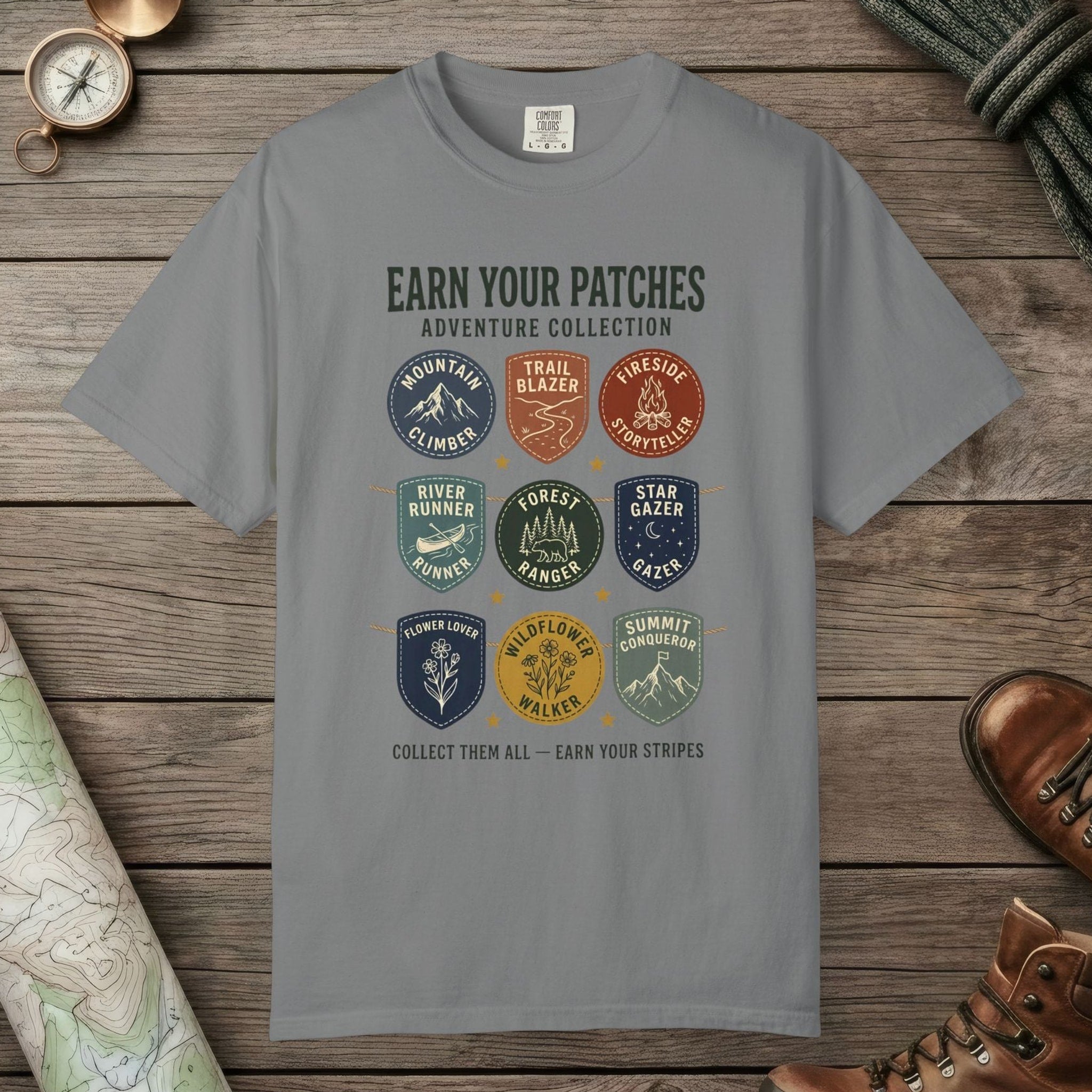 Grey color unisex graphic t-shirt with "Vintage Trail Patches" design